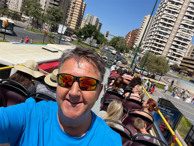 Mark on an open top bus taking in the sights of Malaga