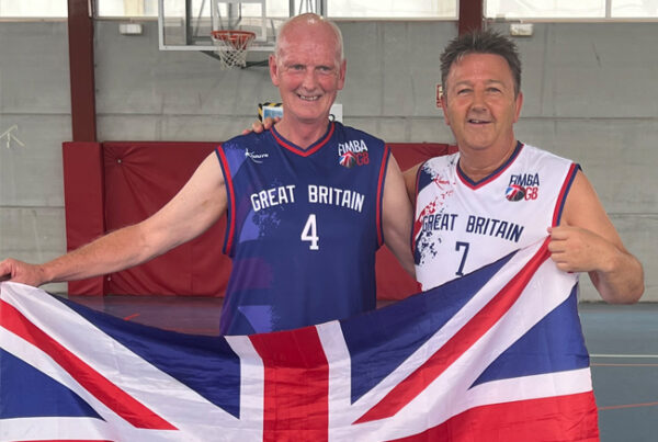 Photo of Mark and GB team mate holding Union Jack flag