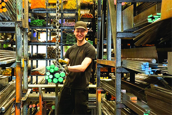 High Peak Steels worker in warehouse moving steel stock