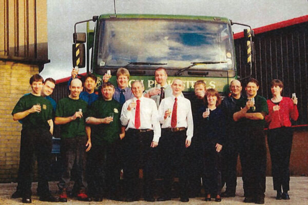Archive footage of High Peak Steels team drinking champagne